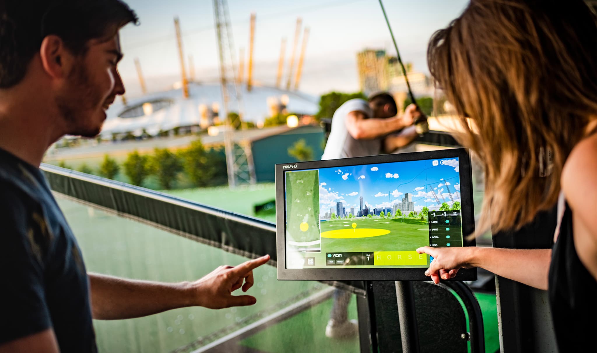 Man and woman using screen