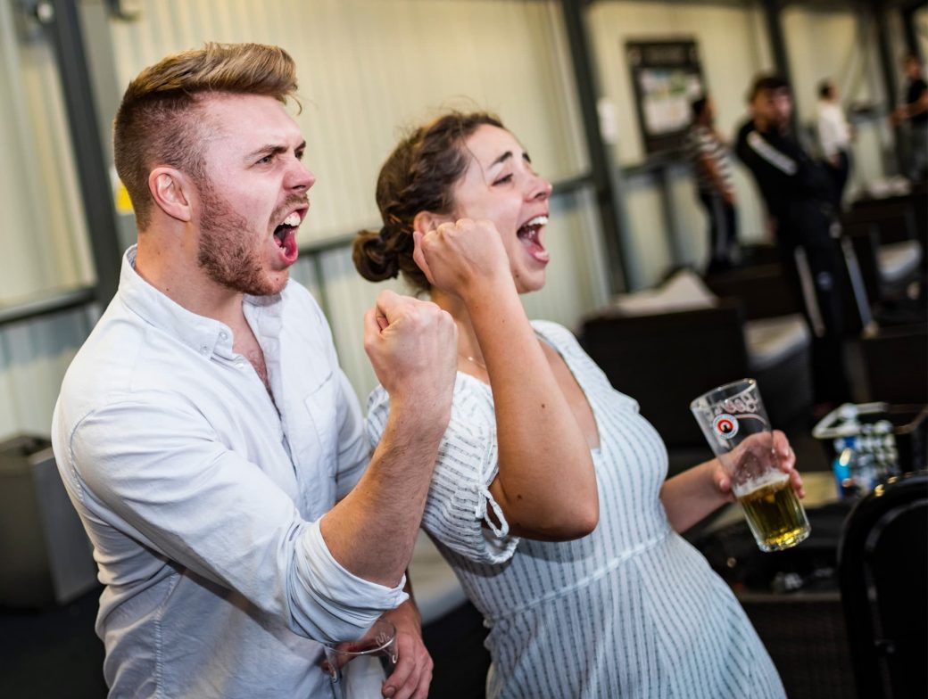 Man and woman celebrating golf results